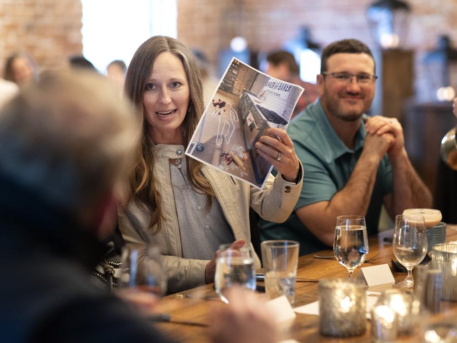 Guests comparing clue cards at their table